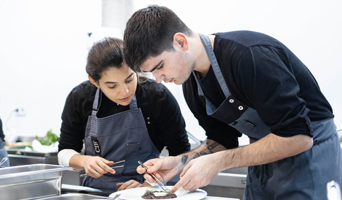 Student to be a chef cooking a dish in the kitchen